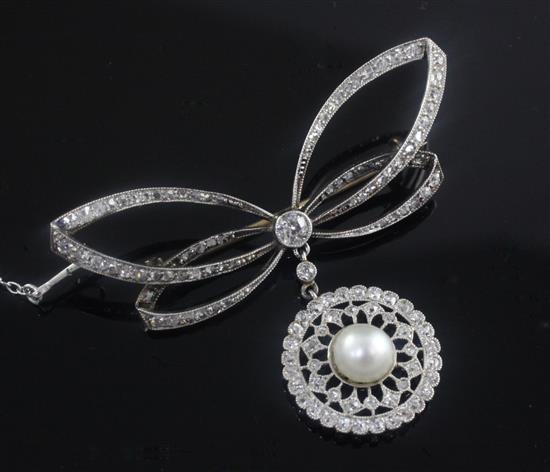 A Belle Epoque platinum and gold, diamond and split pearl set bow brooch with openwork target drop, width 2in.